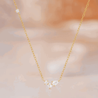 Gold-tone delicate necklace featuring three round and one pear cubic zirconia stones