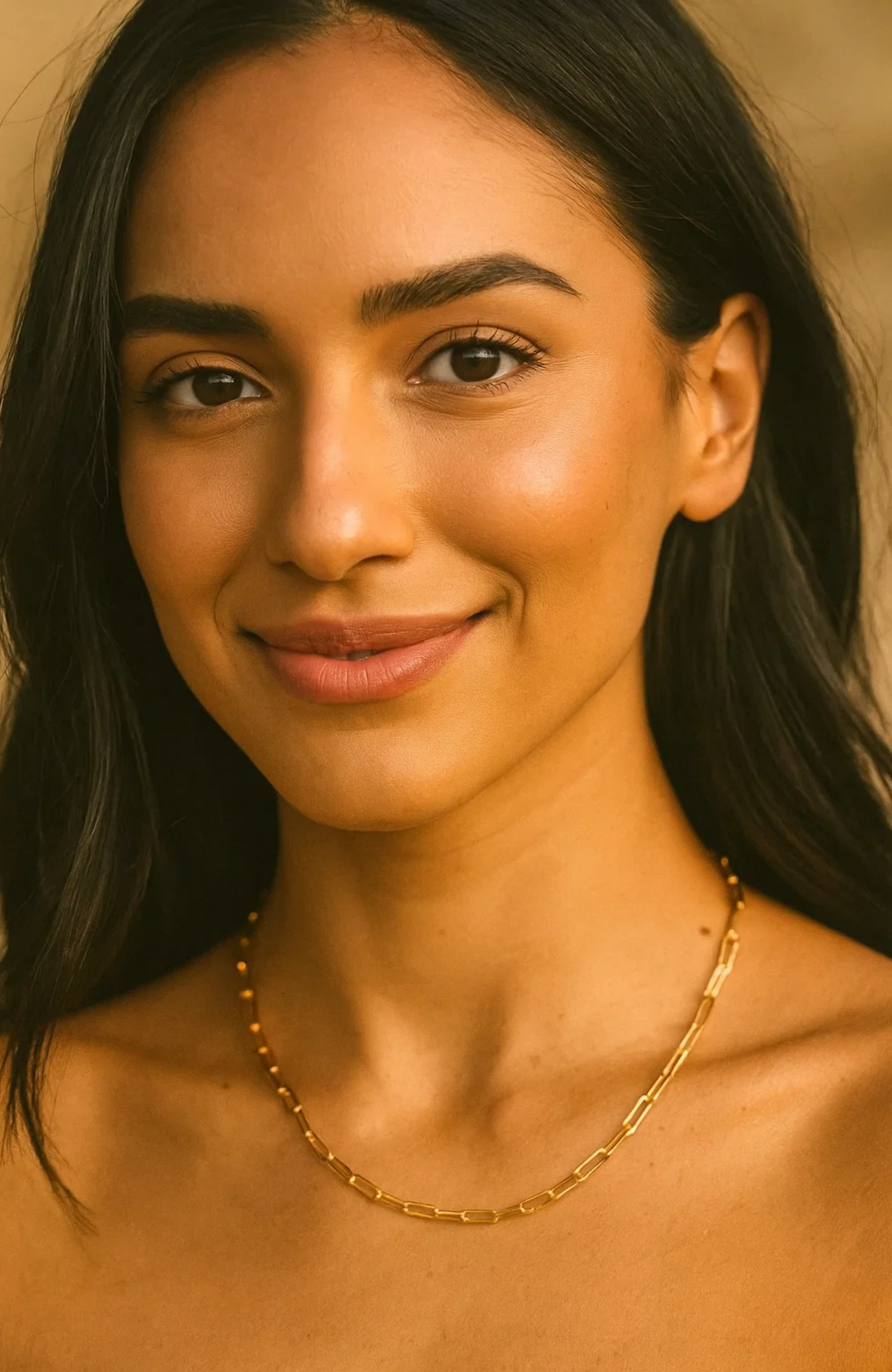 Gold paperclip-link necklace on model neckline with evenly spaced chain links