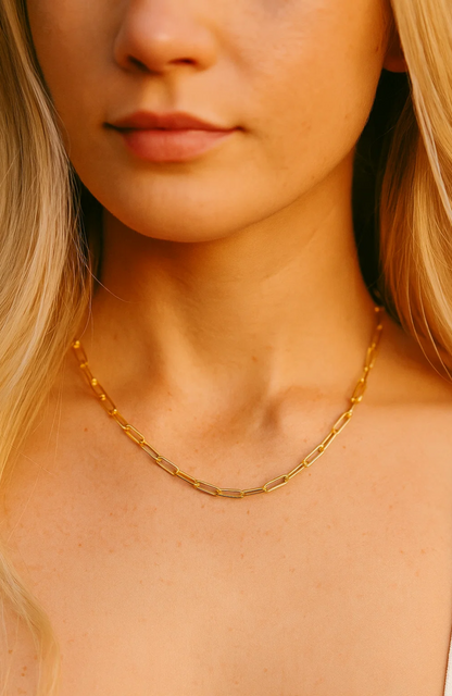 Gold paperclip-link necklace worn close to the collar with small oval links