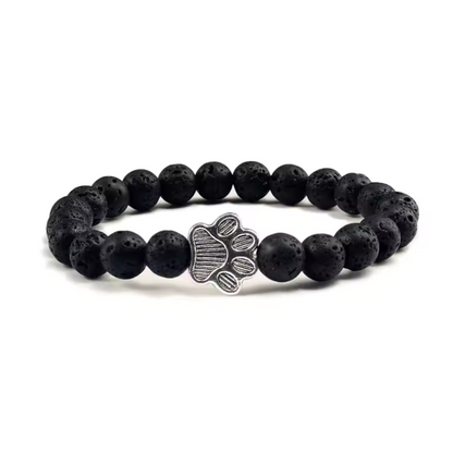 Black beaded charm bracelet with silver paw print centerpiece