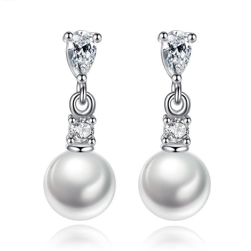 Silver-tone pearl drop earrings with cubic zirconia accents and dangling round pearl