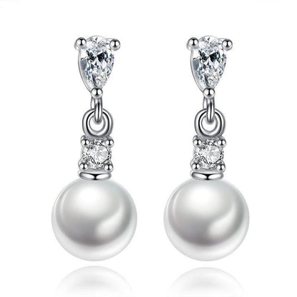 Silver-tone pearl drop earrings with cubic zirconia accents and dangling round pearl