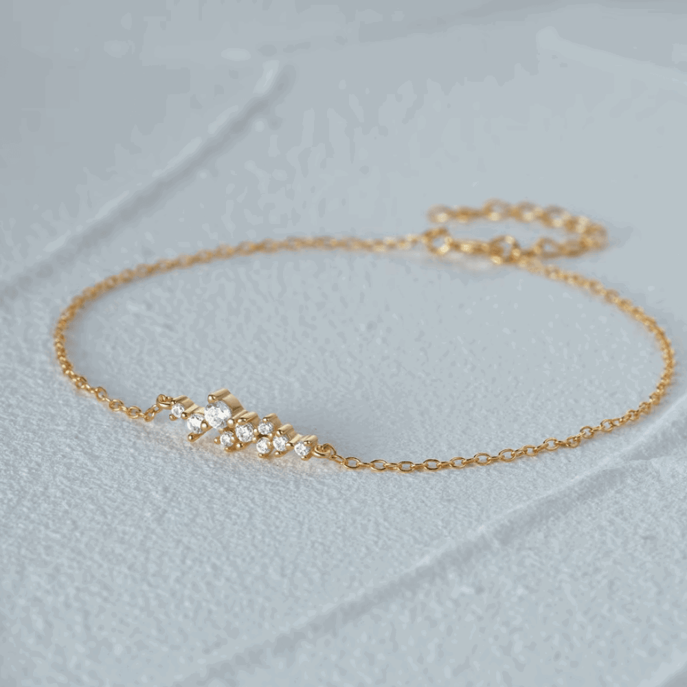 Gold-tone chain link bracelet with small round cubic zirconia cluster at center