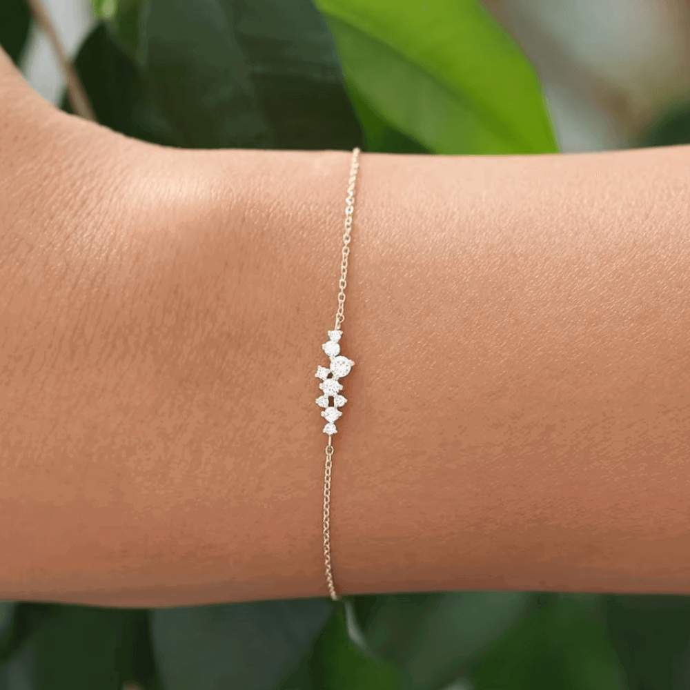 Rose gold–tone chain bracelet with three round cubic zirconia charms on links