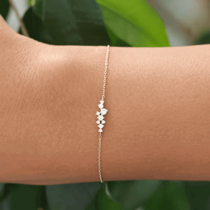 Rose gold–tone chain bracelet with three round cubic zirconia charms on links