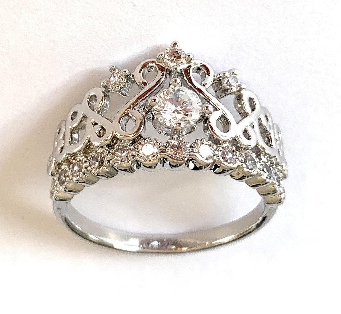 Silver crown ring with large round cubic zirconia center and small accent stones