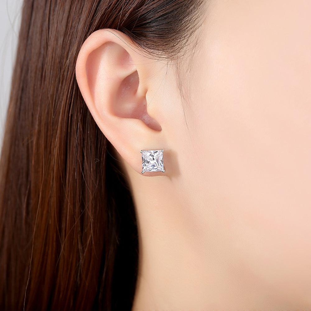 Princess-cut cubic zirconia stud earrings on ear, square clear stone in silver setting