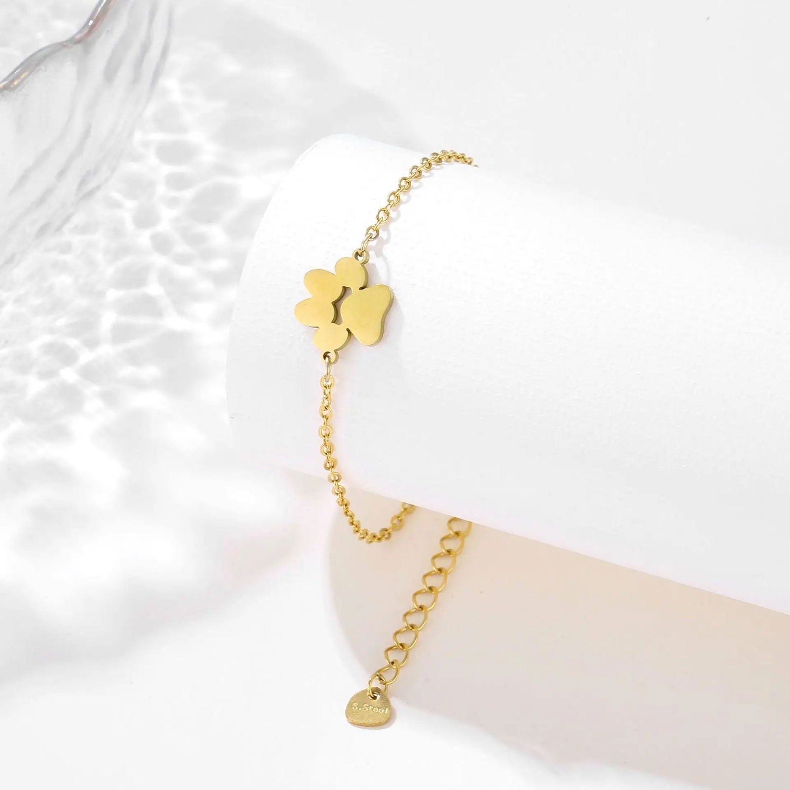 Gold link chain paw cutout charm bracelet with large paw charm and small disc charm