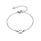 Silver link chain paw cutout charm bracelet with dangling paw charm and small tag charm