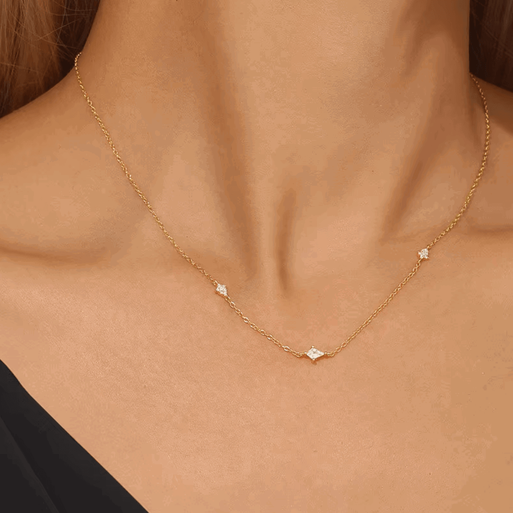 Gold-tone starburst necklace with clear crystal pendant on delicate chain