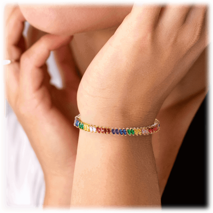 Rainbow tennis bracelet on wrist with small marquise multicolor stones
