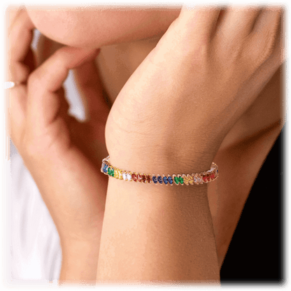 Rainbow tennis bracelet on wrist with small marquise multicolor stones