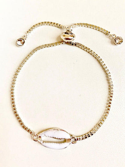 Silver seashell bracelet with beaded chain, oval shell charm, and three crystal details