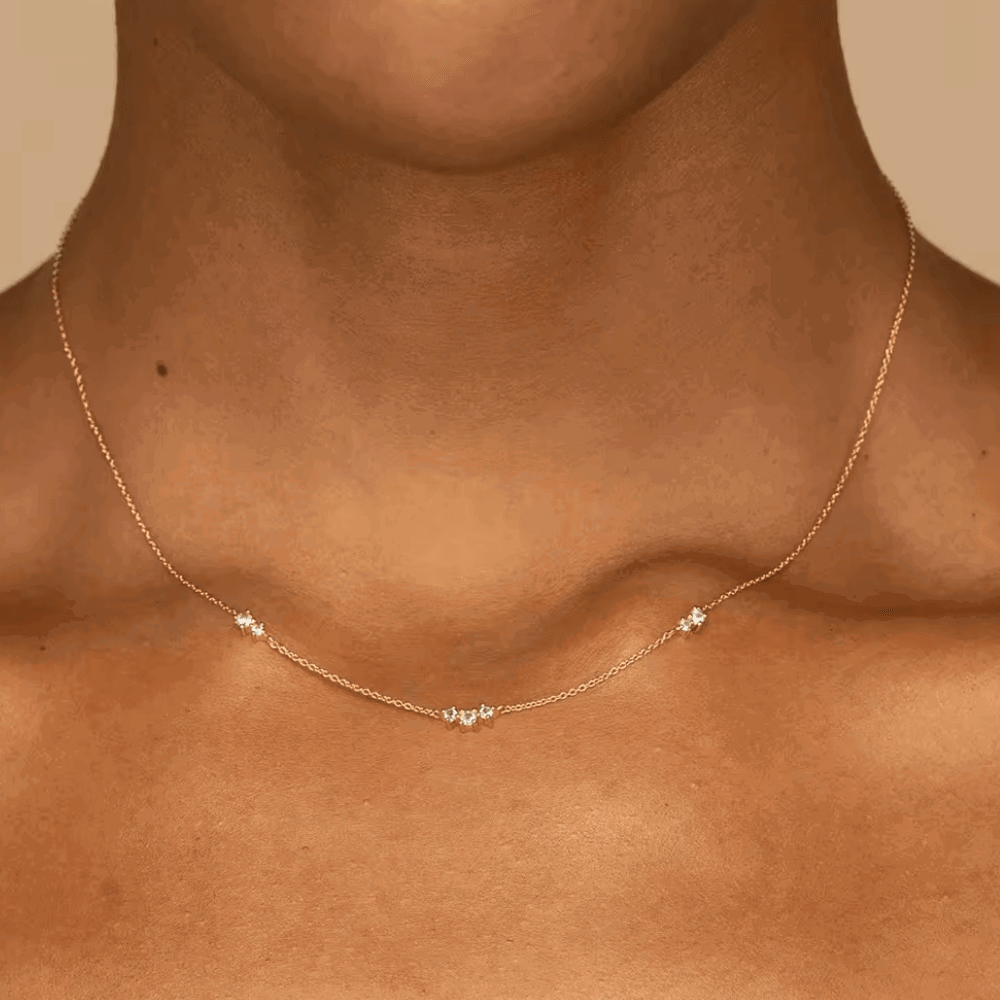 Gold-tone necklace with seven small round cubic zirconia stones at center