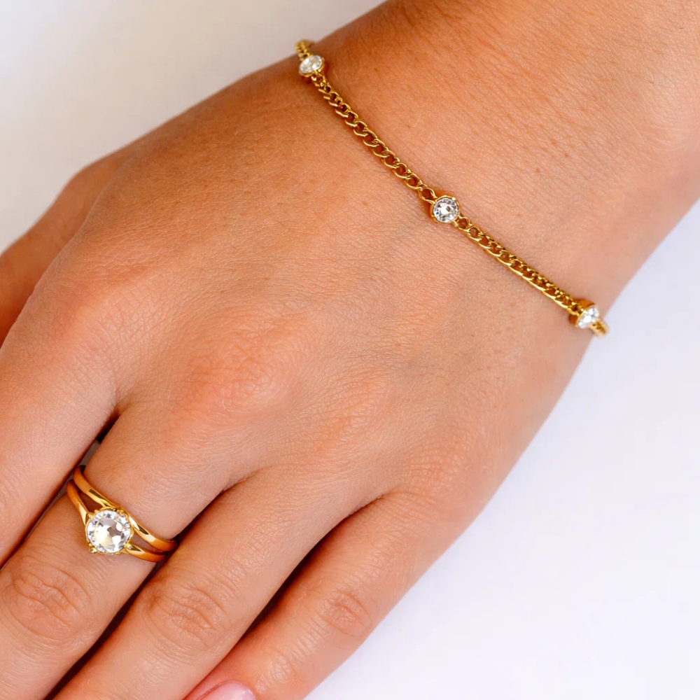 Gold bezel link bracelet with round clear stones and toggle clasp detail