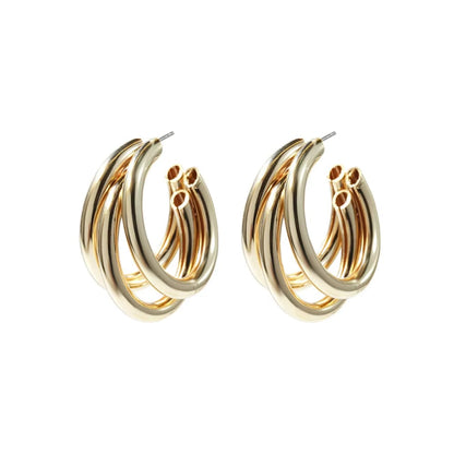 Gold triple huggie hoop earrings, stacked curved hoops with small charm detail
