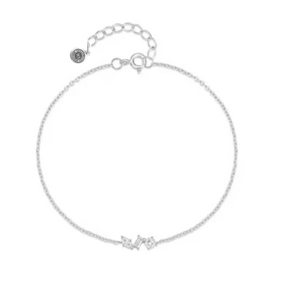 Silver chain link bracelet with cubic zirconia cluster and round logo charm