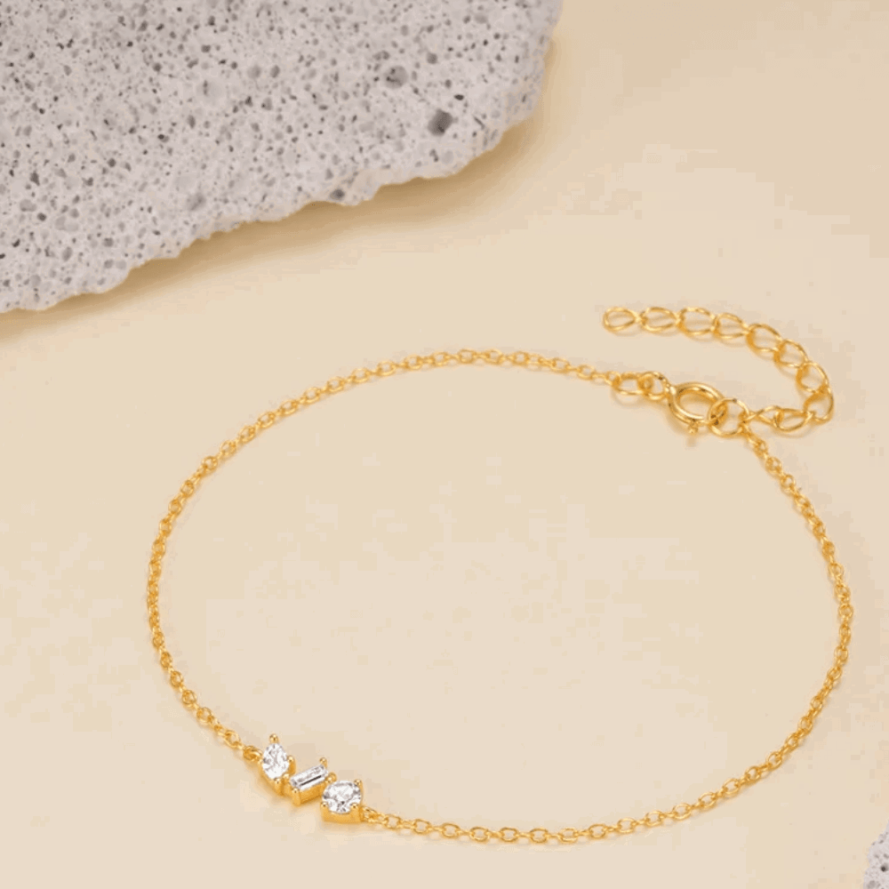 Gold chain link bracelet with cubic zirconia round and princess-cut stones