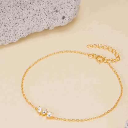 Gold chain link bracelet with cubic zirconia round and princess-cut stones