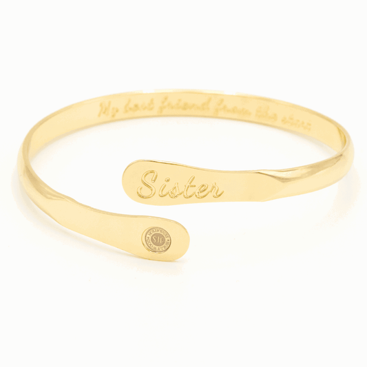 Gold sister engraved cuff bracelet with oval plate and small round emblem