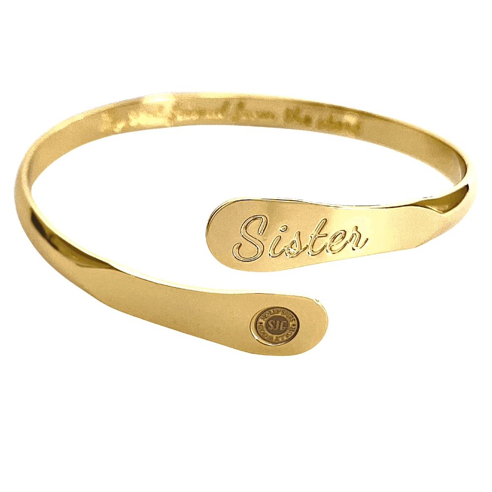 Gold sister bangle bracelet with engraved 'Sister' panel and round seal charm