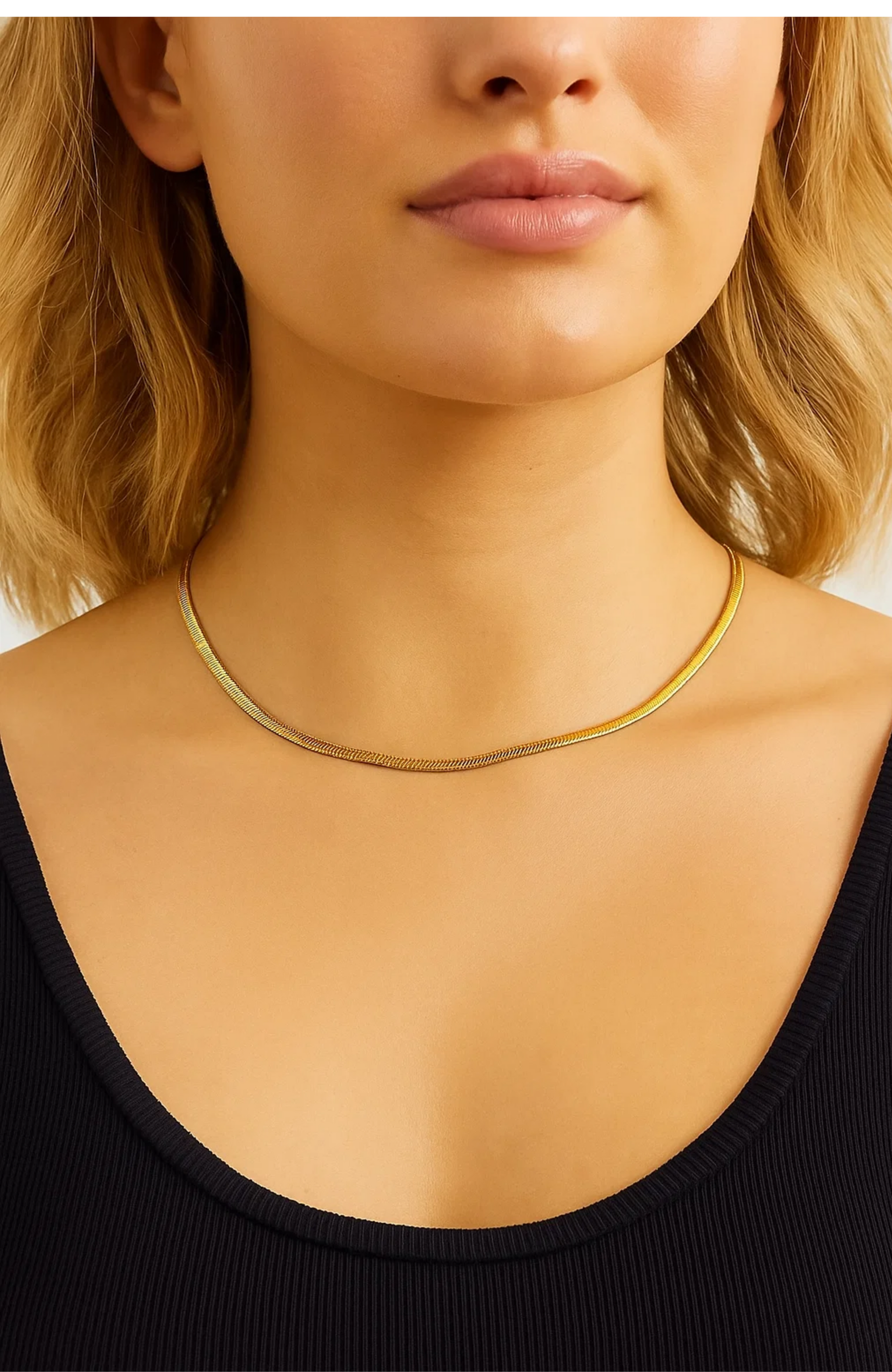 Gold snake chain necklace on neckline, smooth thin chain with fine texture