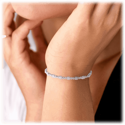 Square tennis bracelet on wrist with white cubic zirconia stones, silver tone