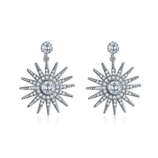 Starburst dangle earrings, silver-tone with white cubic zirconia center and spiked rays