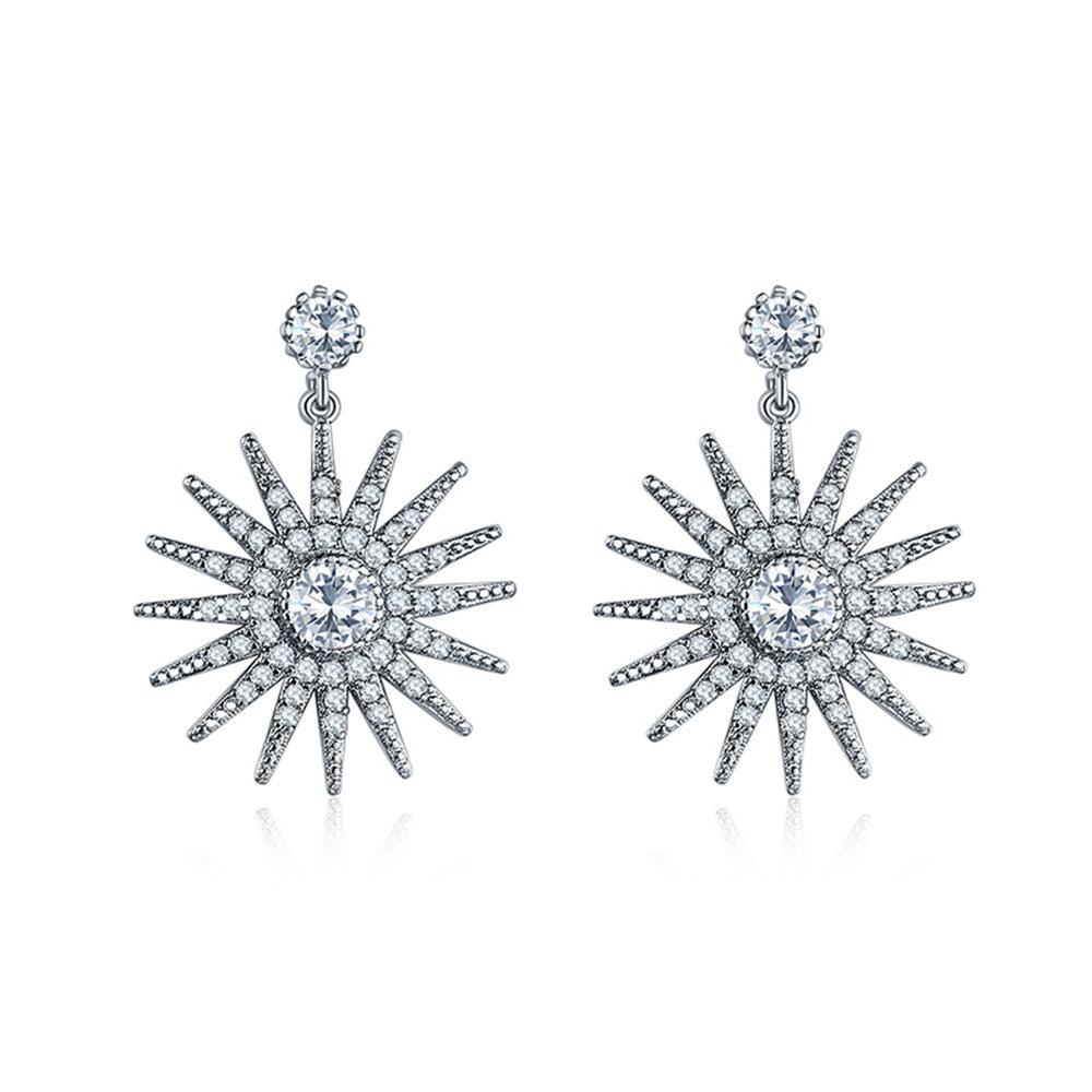 Starburst dangle earrings, silver-tone with white cubic zirconia center and spiked rays