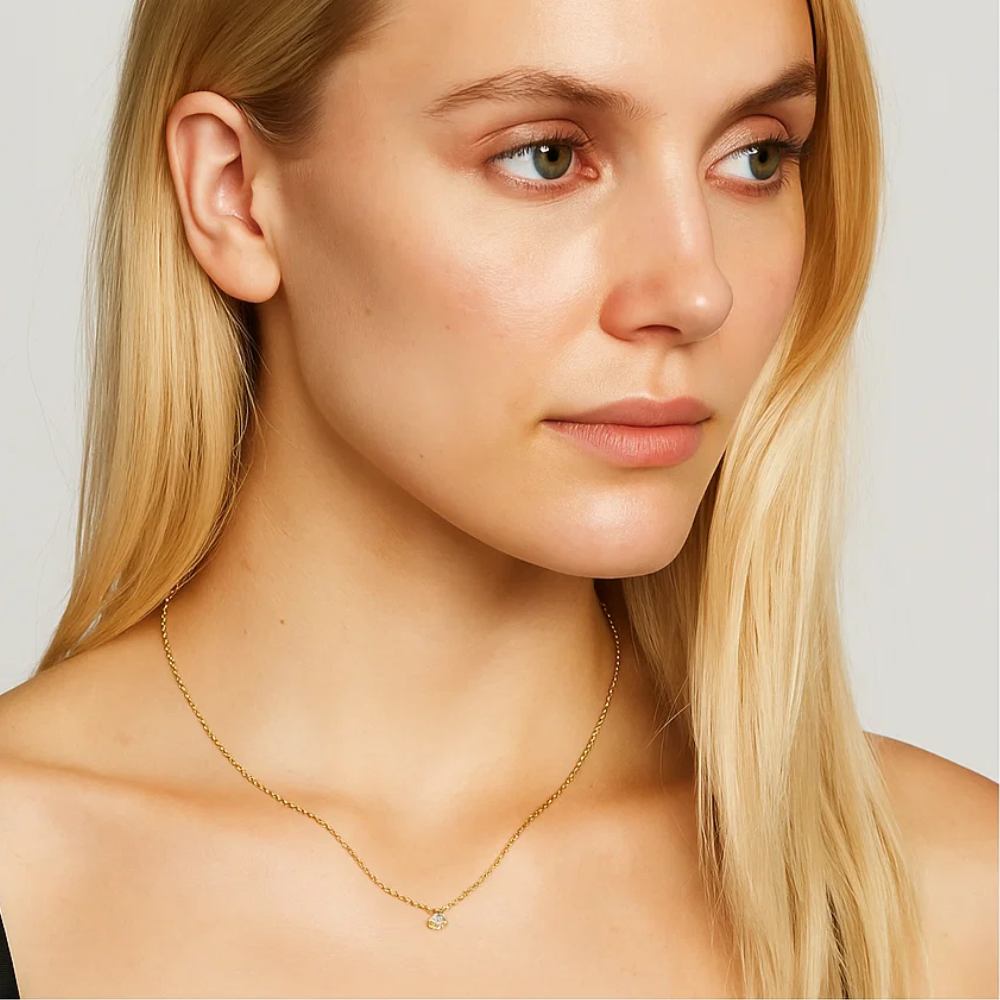 Gold-tone cable chain necklace with round cubic zirconia pendant on model