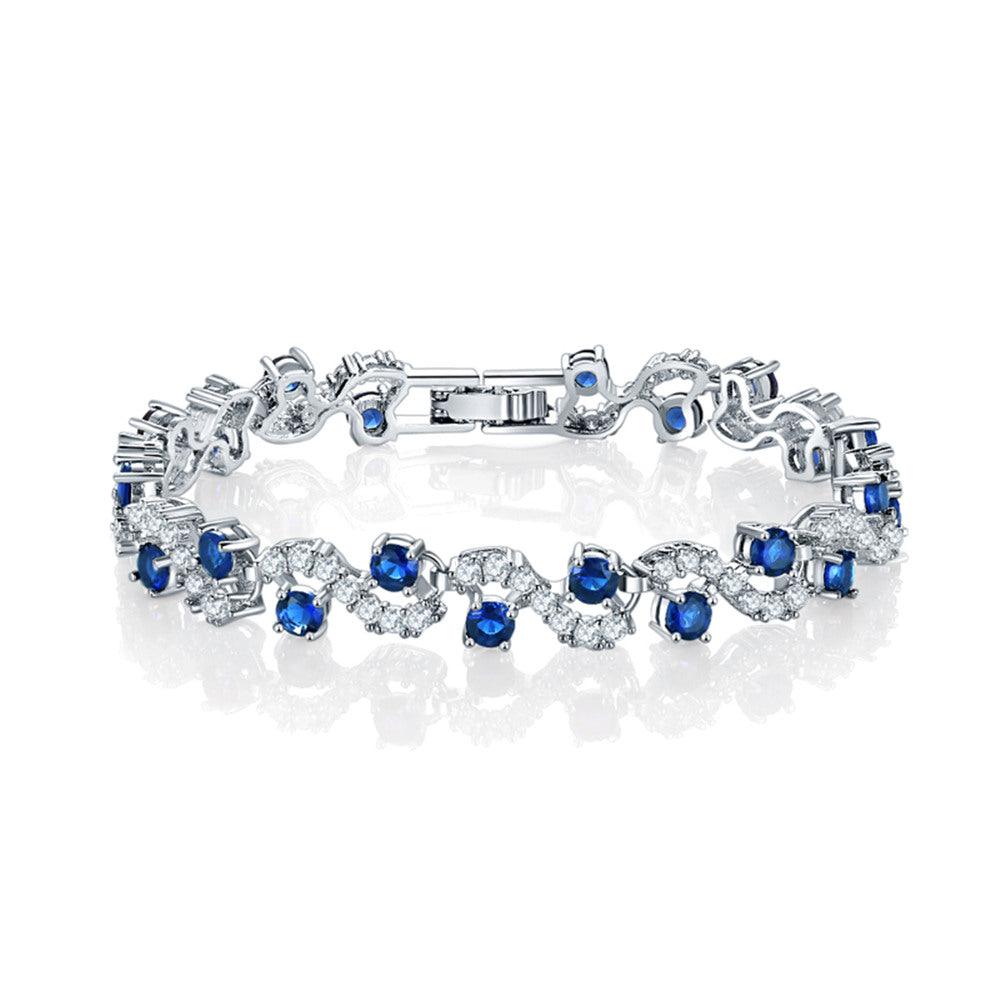 Sapphire blue round-stone tennis bracelet with clear accents, silver-tone links