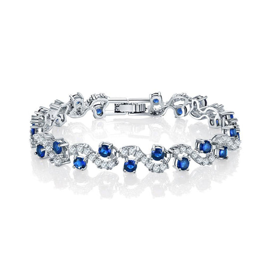 Sapphire blue round-stone tennis bracelet with clear accents, silver-tone links