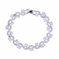 Round-cut cubic zirconia tennis bracelet in silver-tone, flexible oval link design.