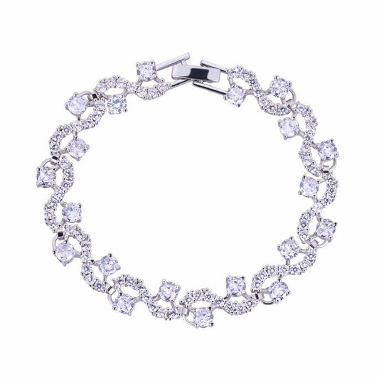 Round-cut cubic zirconia tennis bracelet in silver-tone, flexible oval link design.