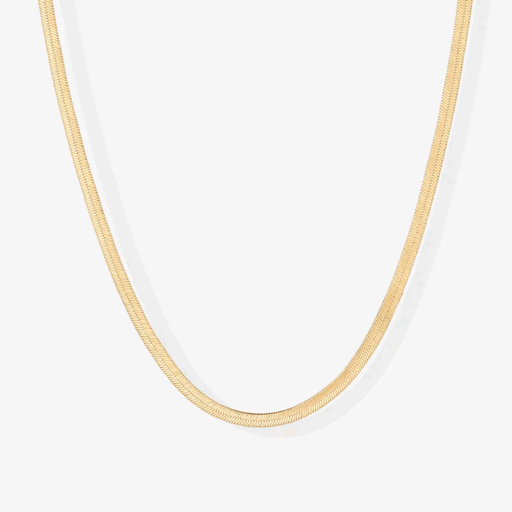 Gold snake chain necklace close-up, smooth slim links