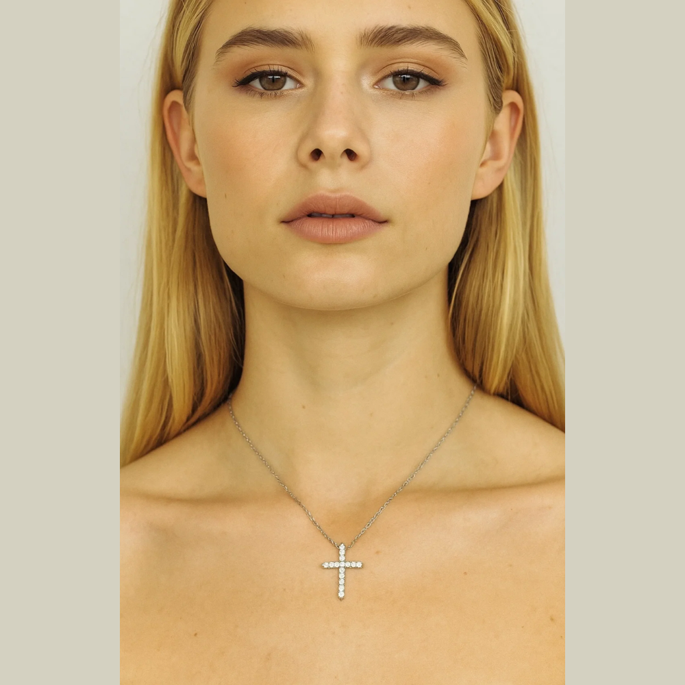 Silver-tone cross pendant necklace with clear CZ stones, centered on neckline