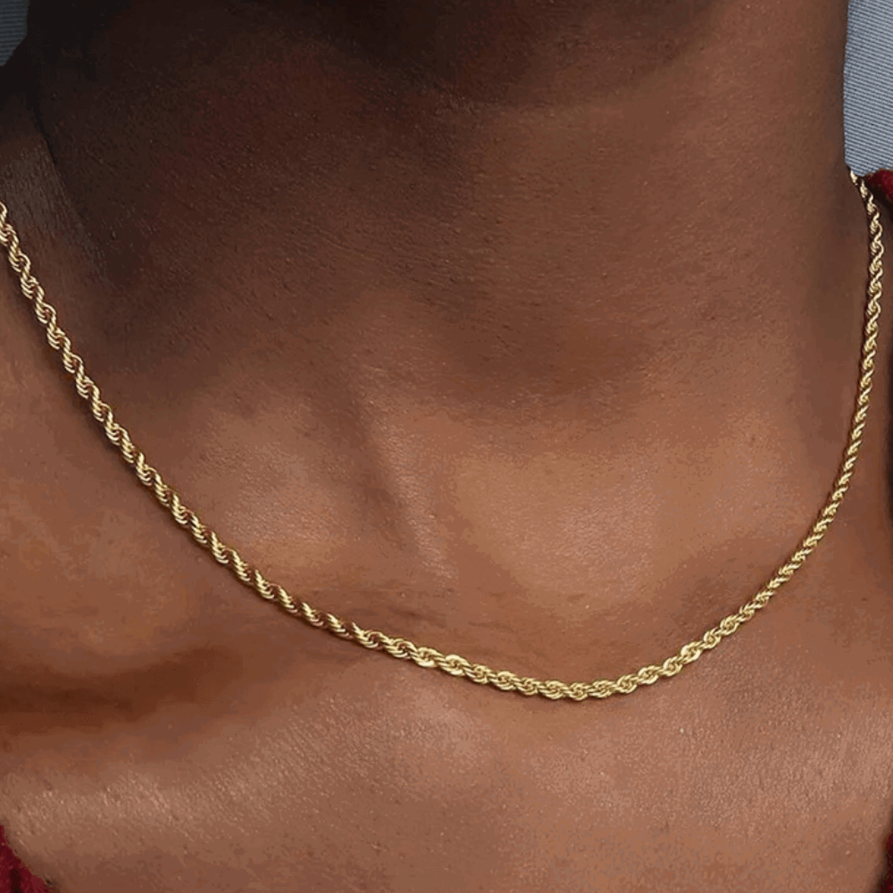 Gold rope chain necklace close-up on neckline
