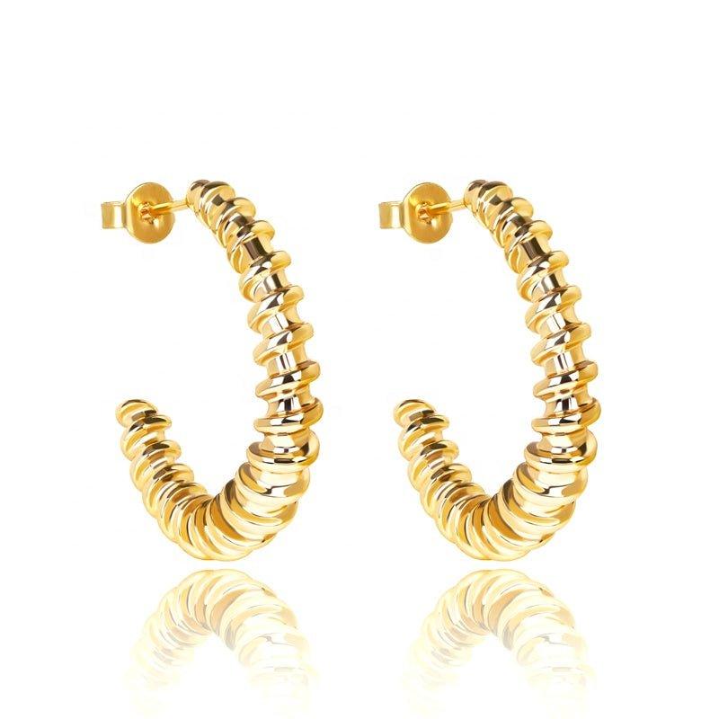 Gold twist hoop earrings with ridged spiral texture and hinged clasp
