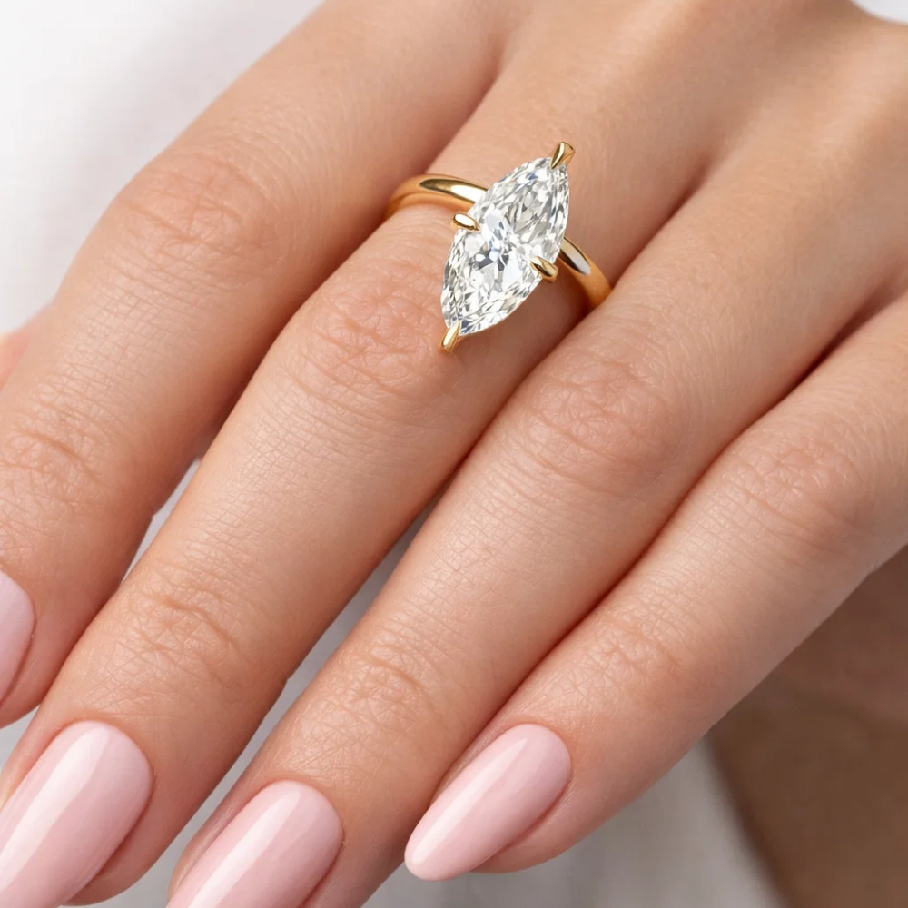 Gold marquise solitaire ring with large clear center gemstone