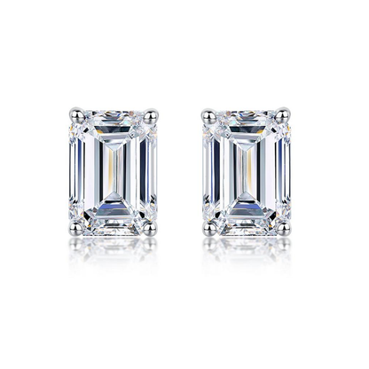 Silver-toned emerald-cut stud earrings with square faceted center stones