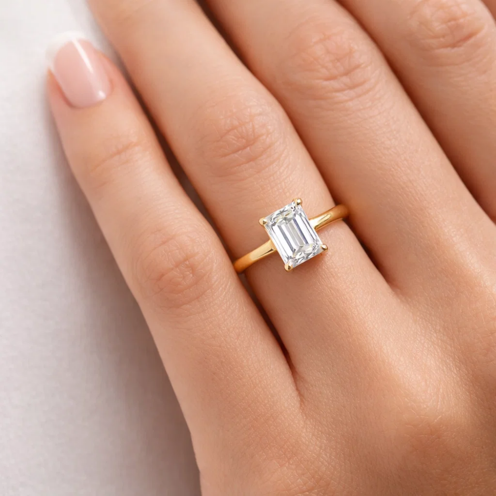 Close-up of gold vermeil emerald-cut solitaire ring with square step-cut center