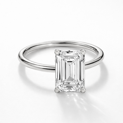 Silver-tone emerald-cut solitaire ring, front view of raised moissanite stone