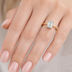 Gold vermeil emerald-cut solitaire ring with rectangular step-cut stone, top view on fingers
