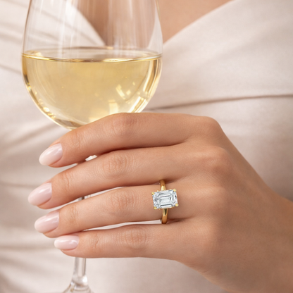Gold vermeil emerald-cut solitaire ring, view from side on hand