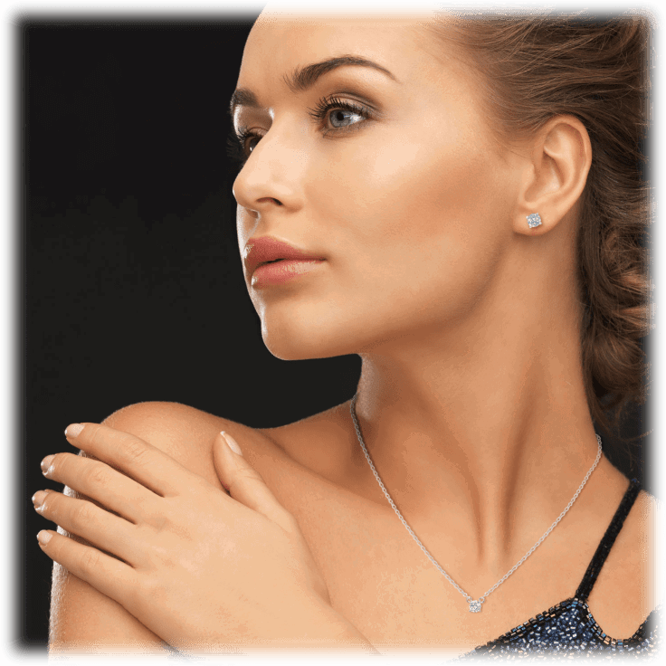 Silver-tone cubic zirconia necklace with round pendant and matching stud earrings on model