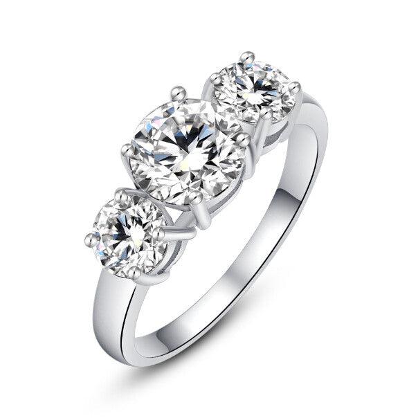 Silver ring with three round cubic zirconia stones in a classic three-stone setting.