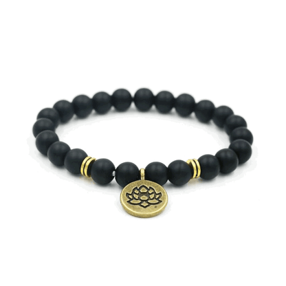 Black bead yoga bracelet with gold lotus charm and two gold accent rings