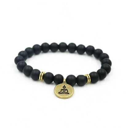 Black bead yoga bracelet with gold Buddha charm and two gold accent rings