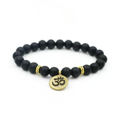 Black bead yoga bracelet with gold Om charm and two gold accent rings