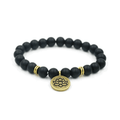 Yoga bracelet with black beads and round lotus charm, gold spacer rings